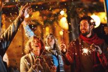 A family celebrating New Years Eve with sparklers 