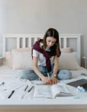Woman studying in bedroom